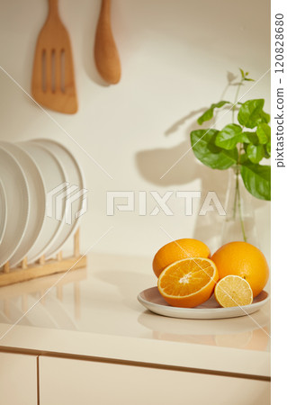 Creative advertising photo template about beige and brown rustic style. A corner of the kitchen cabinets from a high angle shot, decorated with some fruits, green plant vase and disk holders Creative advertising photo template about beige and brown rustic style. A corner of the kitchen cabinets from a high angle shot, decorated with some fruits, green plant vase and disk holders 120828680