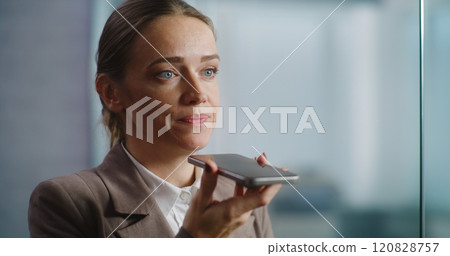 Female marketing manager records voice message in app using smartphone Female marketing manager records voice message in app using smartphone 120828757