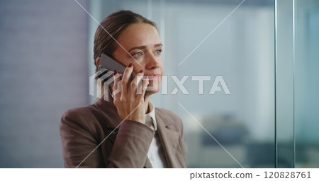 Businesswoman talks to business partner on mobile phone, discusses startup project 120828761