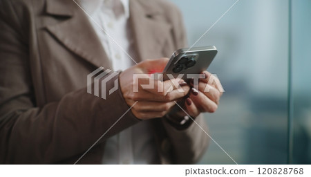 Close up of businesswoman chatting in messenger app on mobile phone 120828768