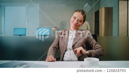 Portrait of successful businesswoman drinking coffee, smiling and looking at camera 120828793