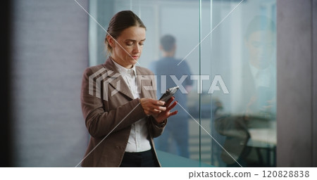 Businesswoman chats with business partner on mobile phone, works in modern office 120828838