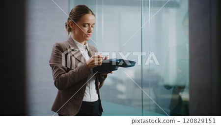 Businesswoman or office worker eats food from delivery during lunch in modern office Businesswoman or office worker eats food from delivery during lunch in modern office 120829151