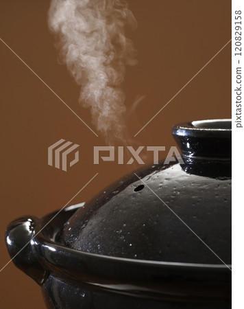 Image of hot pot cooking with steam rising from the clay pot 120829158