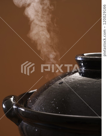 Image of hot pot cooking with steam rising from the clay pot 120829166