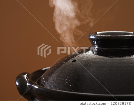 Image of hot pot cooking with steam rising from the clay pot 120829178