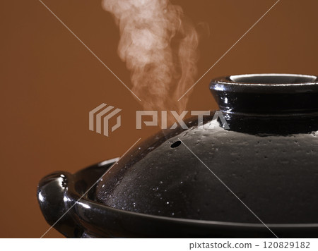 Image of hot pot cooking with steam rising from the clay pot Image of hot pot cooking with steam rising from the clay pot 120829182