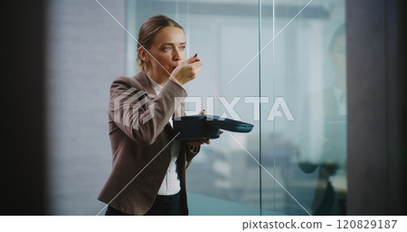 Businesswoman or office worker eats food from delivery during lunch in modern office Businesswoman or office worker eats food from delivery during lunch in modern office 120829187