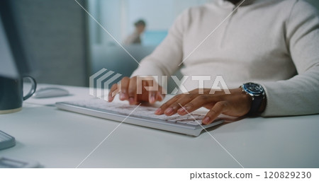 Close up of African American E-commerce manager typing on keyboard, chatting with client using PC 120829230