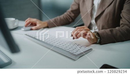 Close up of businesswoman typing on keyboard, chatting with client using PC 120829234