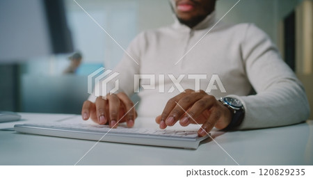 Close up of African American businessman communicating with business partner using computer Close up of African American businessman communicating with business partner using computer 120829235