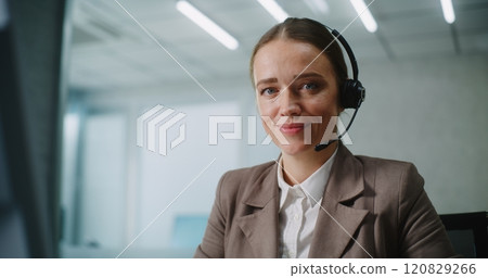Portrait of female E-commerce manager talking, consulting customer on call using headset Portrait of female E-commerce manager talking, consulting customer on call using headset 120829266