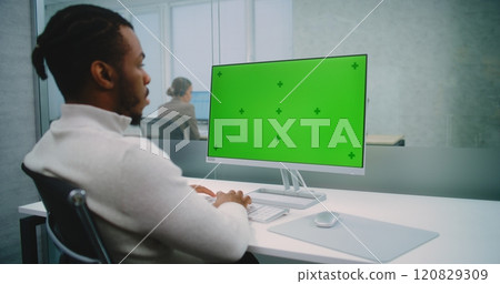 African American financial expert works on personal computer with green screen chromakey 120829309