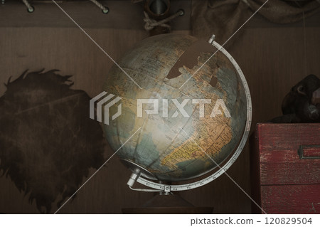 Still life photo of an old vintage globe and nostalgic interior 120829504