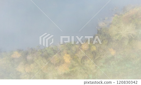 A Serene and Picturesque Landscape Adorned with Stunning Vibrant Autumn Foliage Gazing Under Mist A Serene and Picturesque Landscape Adorned with Stunning Vibrant Autumn Foliage Gazing Under Mist 120830342