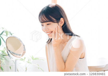 Smiling woman doing skin care Smiling woman doing skin care 120830481