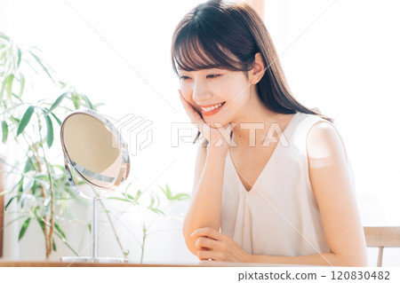 Smiling woman doing skin care Smiling woman doing skin care 120830482