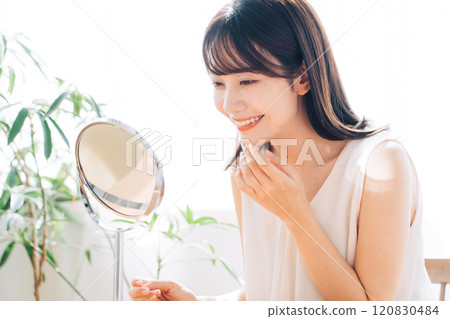 Smiling woman doing skin care 120830484