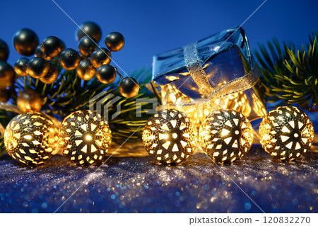 Beautiful Christmas decorations displayed with a gift box in the background 120832270
