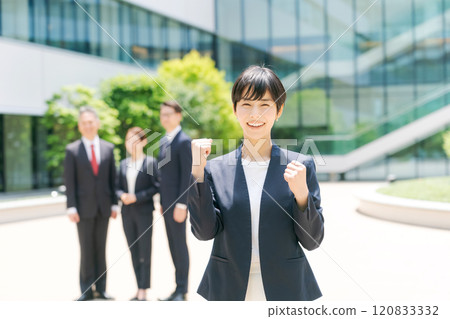 Young woman in a suit wearing a guts pose 120833332