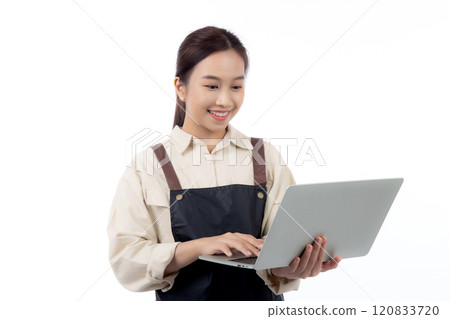Portrait young asian business woman wearing apron holding laptop computer isolated white background. 120833720