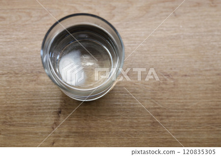 Top view of glass with effervescent soluble tablet 120835305