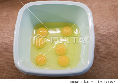 Four Yellow Eggs in plastic bowl Four Yellow Eggs in plastic bowl 120835307