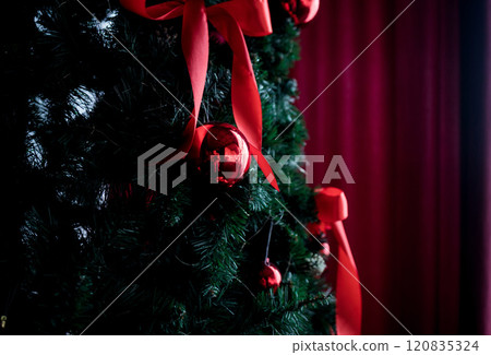 Festive christmas tree with red ribbons Festive christmas tree with red ribbons 120835324