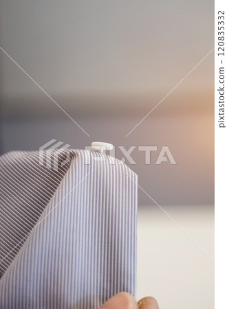 Plastic button on shirt. 120835332