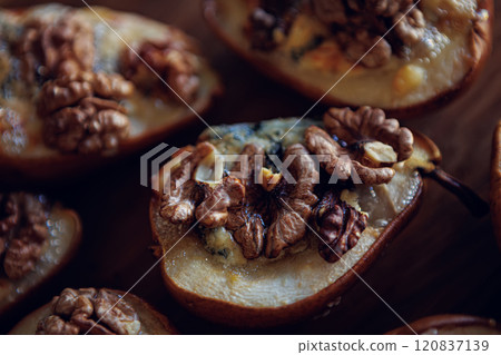 Baked pears topped with walnuts and blue cheese, capturing a rustic and comforting feel Baked pears topped with walnuts and blue cheese, capturing a rustic and comforting feel 120837139
