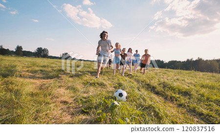 Excited graduates play soccer on a sunny field, celebrating achievement and future success with friends Excited graduates play soccer on a sunny field, celebrating achievement and future success with friends 120837516