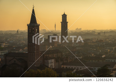 Sunset over historic Verona cityscape with iconic towers and buildings 120838242