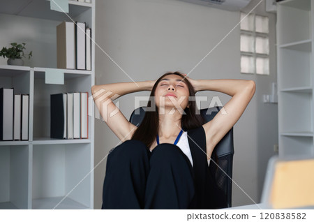 Stressed Business Woman at Work in Modern Office Environment Experiencing Overwhelm and Fatigue 120838582