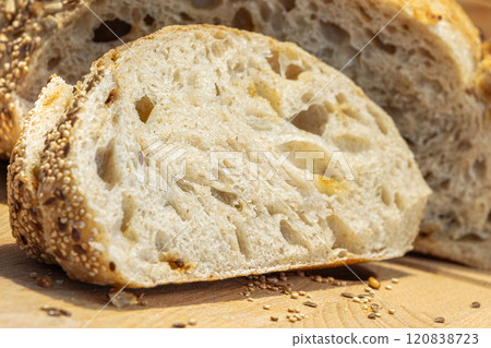Slice of sourdough bread cut from a loaf close-up Slice of sourdough bread cut from a loaf close-up 120838723
