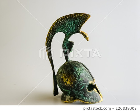 Bell in the form of an ancient Greek helmet made of bronze on a white background. Bell in the form of an ancient Greek helmet made of bronze on a white background. 120839302
