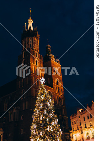 Saint Mary's Basilica in Cracow during Christmas winter season. Main square of Krakow. Winter holidays and celebration concept Saint Mary's Basilica in Cracow during Christmas winter season. Main square of Krakow. Winter holidays and celebration concept 120840295