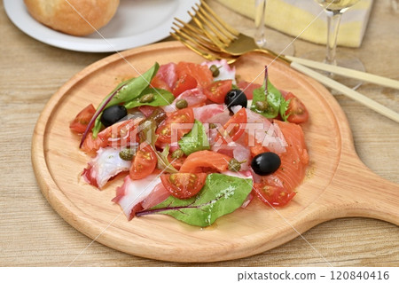 Carpaccio, carpaccio salad. Salmon, sea bream, octopus, cherry tomatoes, baby leaves, olive oil. 120840416