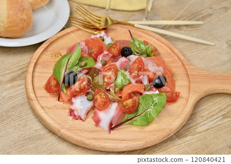 Carpaccio, carpaccio salad. Salmon, sea bream, octopus, cherry tomatoes, baby leaves, olive oil. Carpaccio, carpaccio salad. Salmon, sea bream, octopus, cherry tomatoes, baby leaves, olive oil. 120840421