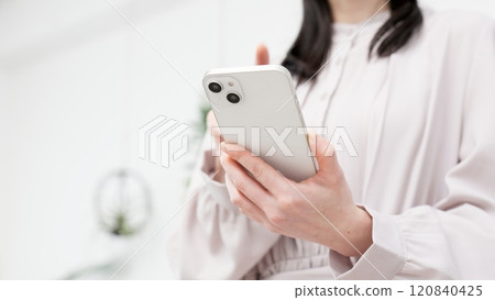 Hand of a woman who operates a smartphone 120840425