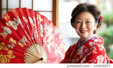 Joyful woman in red kimono celebrating Christmas Joyful woman in red kimono celebrating Christmas 120840875