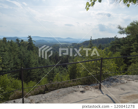 Panoramic view from sandstone rock viewpoint Ponorka, submarine at the top of 3 sandstone towers near Ceska Kamenice town. Summer landscape in Lusatian Mountains, green hills,oak and pine tree forest. Panoramic view from sandstone rock viewpoint Ponorka, submarine at the top of 3 sandstone towers near Ceska Kamenice town. Summer landscape in Lusatian Mountains, green hills,oak and pine tree forest. 120841278
