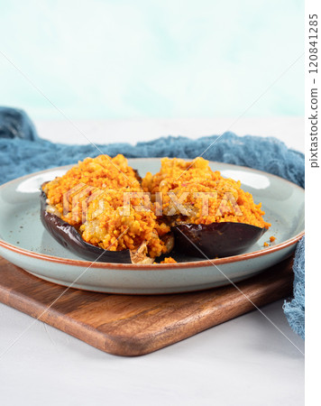 Baked eggplants stuffed with corn couscous with chickpea sauce Baked eggplants stuffed with corn couscous with chickpea sauce 120841285