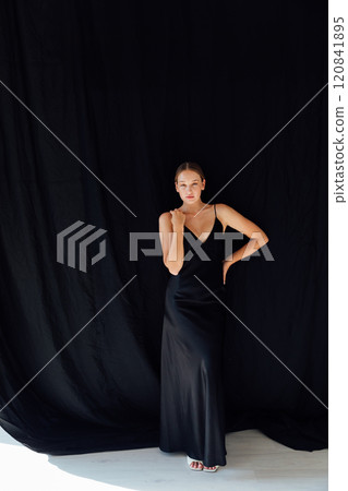 Beautiful fashion woman in black evening silk dress 120841895