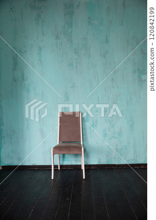 One vintage chair in the interior of an empty blue room One vintage chair in the interior of an empty blue room 120842199