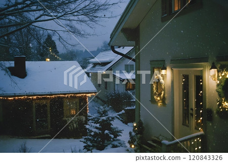 Snow covered houses in the village with christmas decorations 120843326