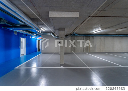 Empty parking garage with blue walls and ventilation pipes 120843683