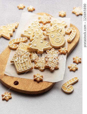 Christmas sugar cookies decorated with royal icing on wooden board 120843890