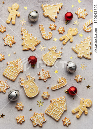 Christmas cookies forming a festive background with ornaments Christmas cookies forming a festive background with ornaments 120843891