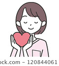 A female nurse with her eyes closed and holding a heart 120844061