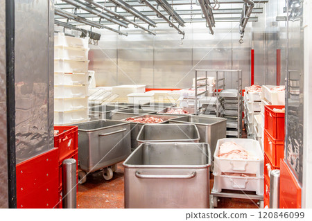 Meat processing plant storing pork cuts in metal containers Meat processing plant storing pork cuts in metal containers 120846099